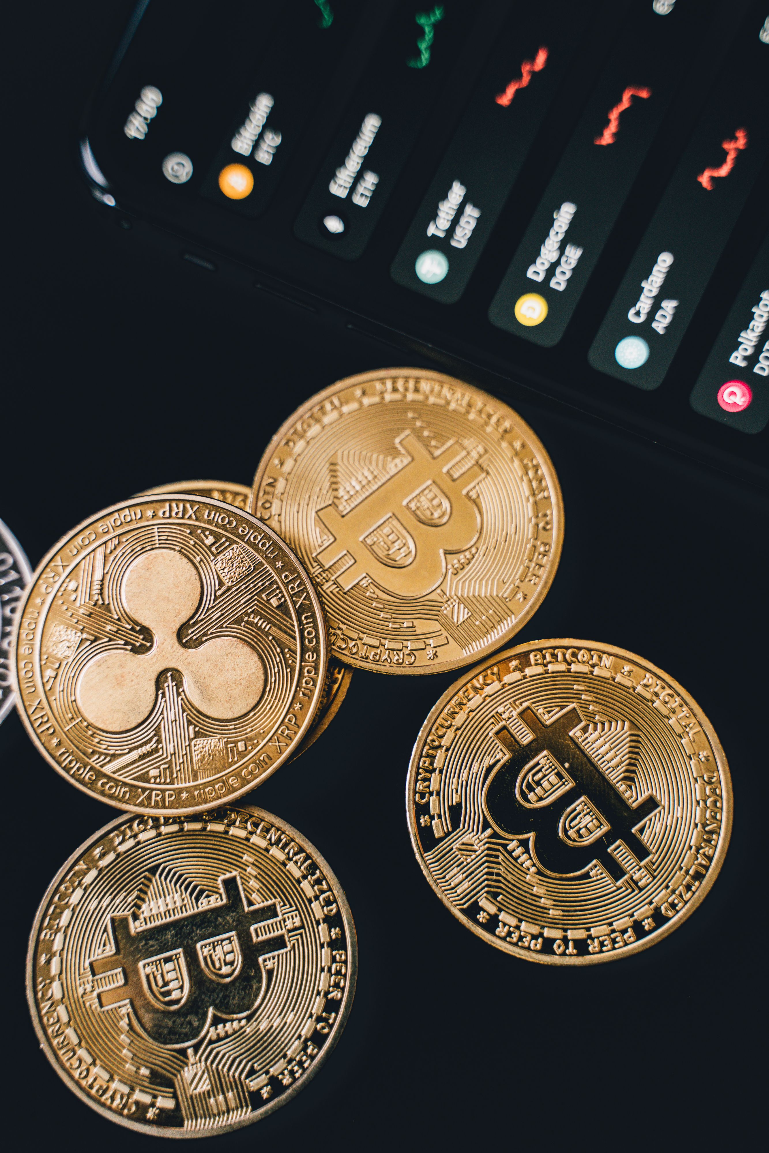 Cryptocurrency coins with market data representing cashing out to fiat